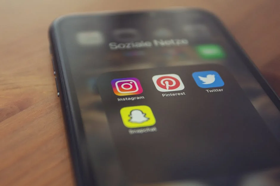 Smartphone displaying social media apps including Instagram and Snapchat representing community features