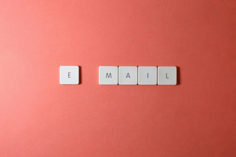 Keyboard letter tiles spelling email on coral background representing email capture and list building