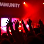 Community members raising hands representing member spotlight and recognition