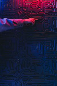 Hand interacting with glowing circuit board representing AI integration in community platforms