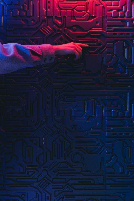 Hand interacting with glowing circuit board representing AI integration in community platforms